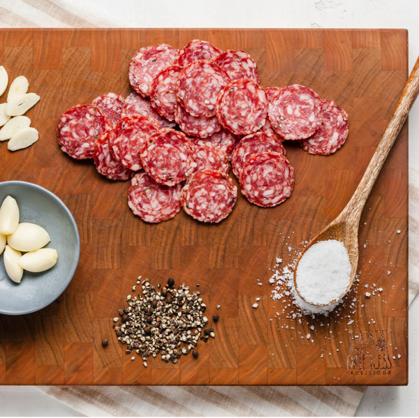 salami saucisson sec slices on board with ingedients