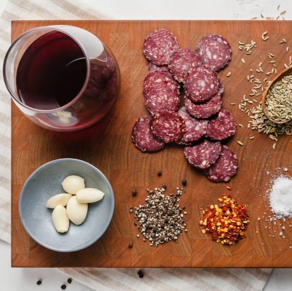venison salami picante slices on board with ingredients