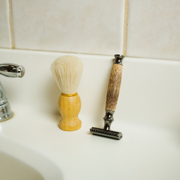 Shave brush and a razor standing on the sink